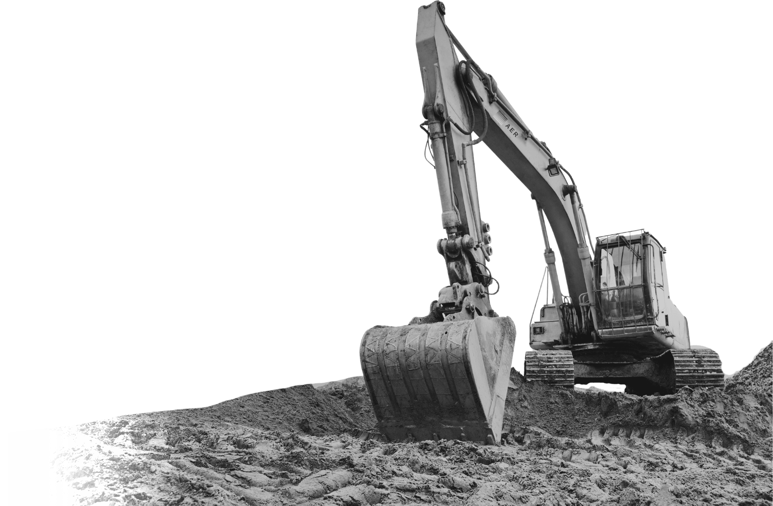 Tracked excavator on a spoil pile with its bucket lowered